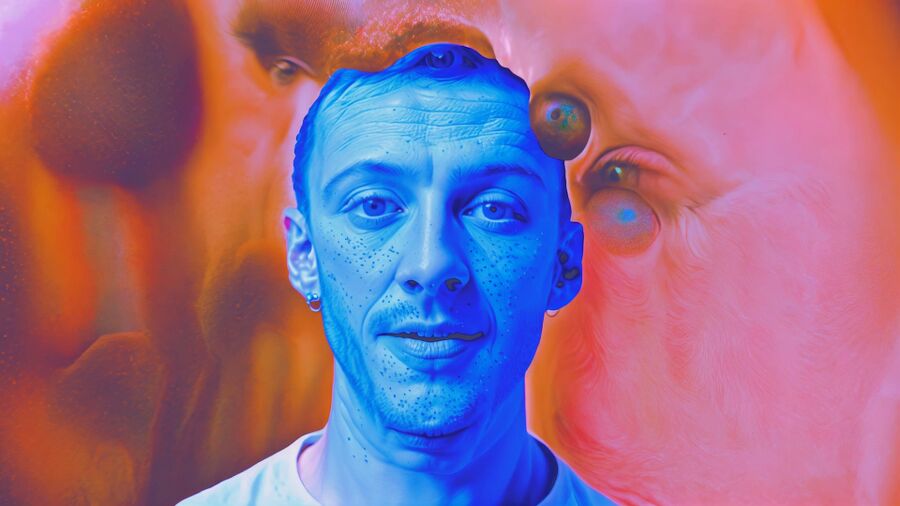 Video still from the artist's video, RAPTURE, showing a blue male face morphing into a pink and orange psychedelic background