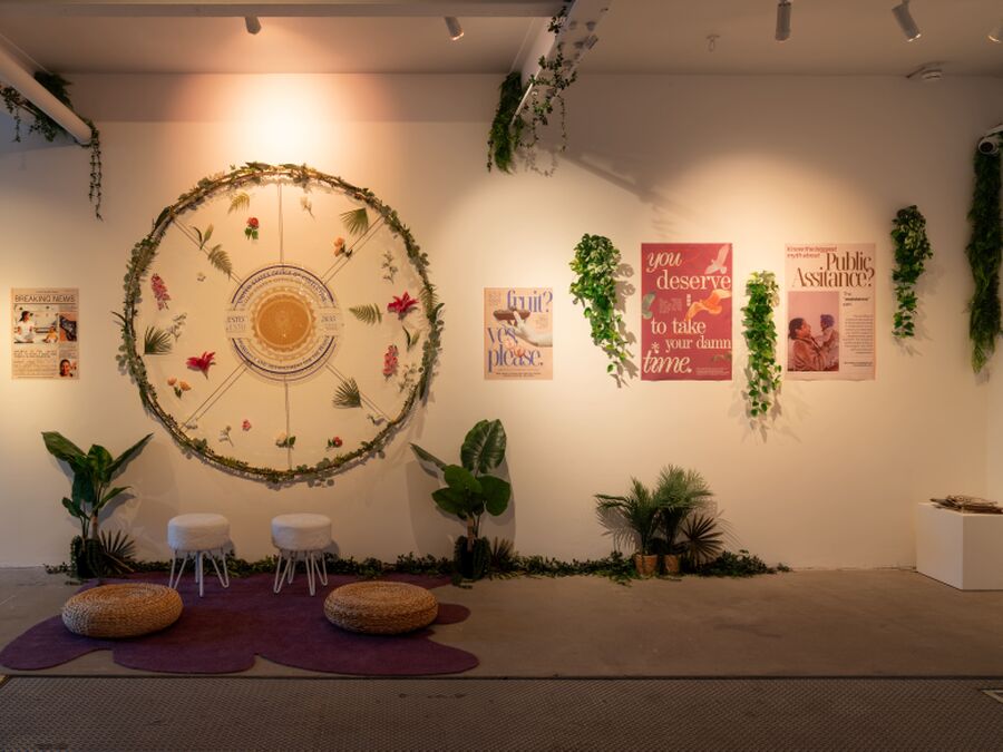 Photo from the Fields of Vision exhibition, showing an installation featuring plants, wall art, and sculpture